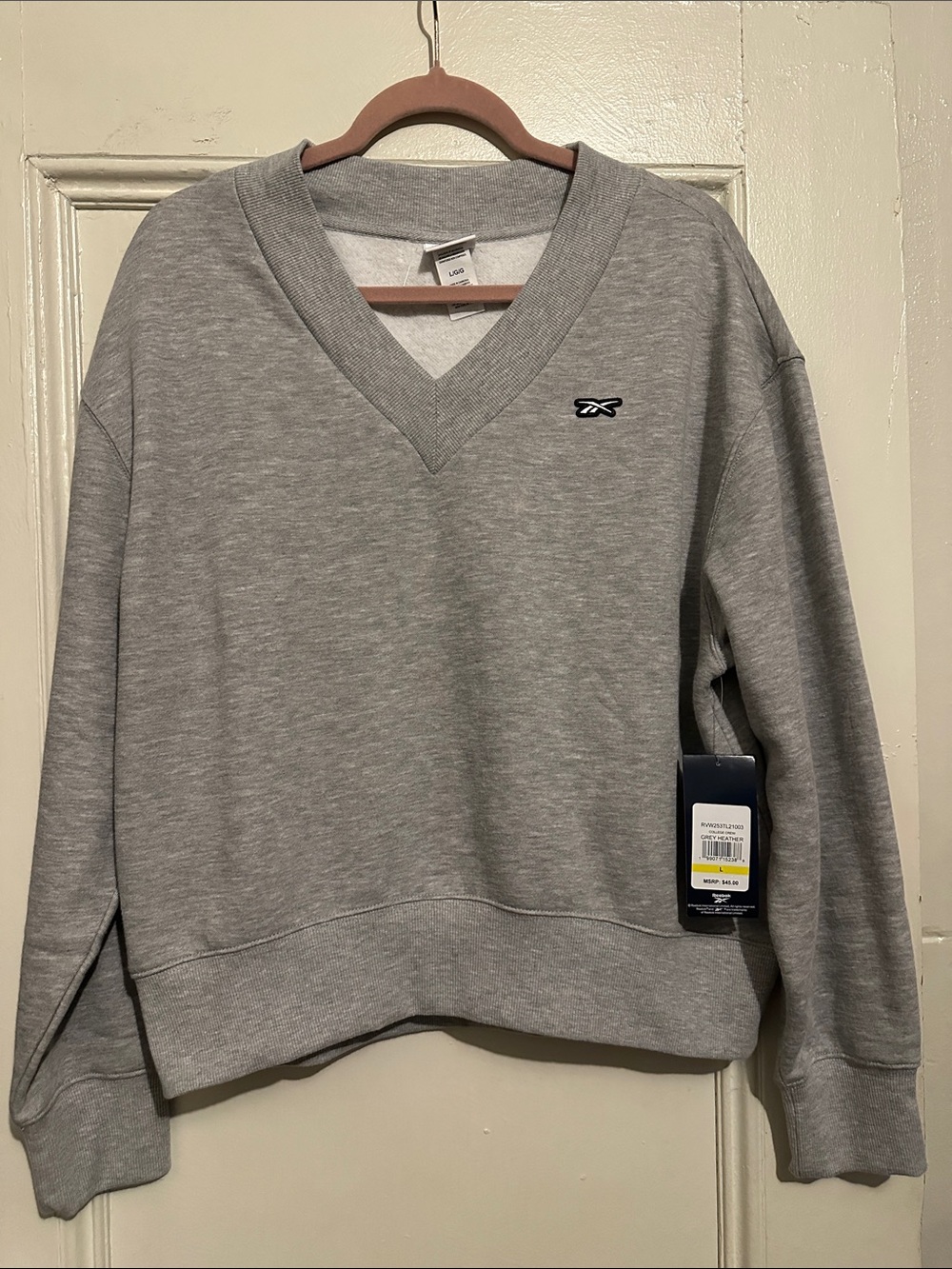 NWT Reebok Women's Light Gray V-Neck Sweatshirt. Size L. 22.25”L x 22.5”W.